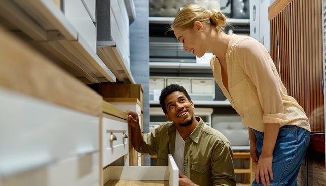 A couple choosing a dresser in a ZSmart Furniture store